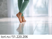 Close up focus on young female feet walking barefoot on clean tile floor at home. Young woman standing on warm floor indoors, underfloor heating concept. Woman's legs in bathroom. Floor heating. Стоковое AI-изображение, AI-художник Марина Демидюк / Фотобанк Лори