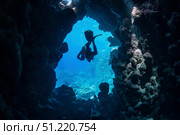 A diver exits an underwater cave, Red Sea. Brook Peterson/Stocktrek Images/TASS. Стоковое фото, агентство ТАСС / Фотобанк Лори