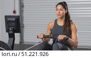 Muscular woman training hard on rowing machine, displaying intense physical strength, core muscle power, and dedicated fitness commitment. Стоковое AI-видео, аниматор Юрий Поздников / Фотобанк Лори