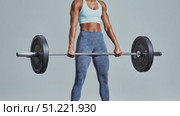 Muscular woman powerlifting heavy barbell, executing precise deadlift movement with strong athletic form in minimalist white setting. Стоковое AI-видео, аниматор Юрий Поздников / Фотобанк Лори