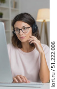 Female professional wearing headset and glasses, working remotely at home desk, providing technical customer support with focused concentration. Стоковое AI-видео, аниматор Юрий Поздников / Фотобанк Лори