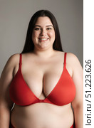 Happy plus size model in red lingerie, fat woman on gray background, obese body. Стоковое AI-изображение, AI-художник Станислав Тарко / Фотобанк Лори