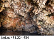 A textured, rocky cave interior with unique natural formations and vivid colors. Стоковое фото, фотограф EugeneSergeev / Фотобанк Лори