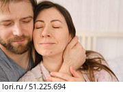 Loving mature couple interactions at home. Husband and wife hugging, holding hands and drinking morning coffee together. Man and woman talk about plans for weekend. Natural lighting. Intimate moments. Стоковое фото, фотограф Марина Демидюк / Фотобанк Лори