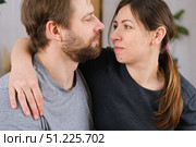 Loving mature couple interactions at home. Husband and wife hugging, holding hands and drinking morning coffee together. Man and woman talk about plans for weekend. Natural lighting. Intimate moments. Стоковое фото, фотограф Марина Демидюк / Фотобанк Лори