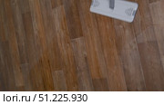 Modern mop washes brown linoleum floors, cleaning concept household chores. Стоковое видео, видеограф Катерина Белякина / Фотобанк Лори