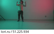 Young child dancing with colorful lighting effects. Стоковое видео, видеограф Константин Шишкин / Фотобанк Лори