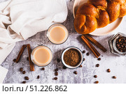 Yemeni coffee with cardamom, cinnamon and cream in glasses on table top view. Стоковое фото, фотограф Елена Руй / Фотобанк Лори