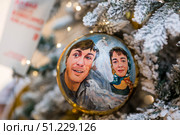 A decorated Christmas tree of the Mosfilm film company with portraits of actors from popular Soviet films, in the GUM store in the center of Moscow. Russia, Moscow, January 9, 2025. Редакционное фото, фотограф Photojuli / Фотобанк Лори