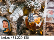 A decorated Christmas tree of the Mosfilm film company with portraits of actors from popular Soviet films, in the GUM store in the center of Moscow. Russia, Moscow, January 9, 2025. Редакционное фото, фотограф Photojuli / Фотобанк Лори
