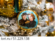 A decorated Christmas tree of the Mosfilm film company with portraits of actors from popular Soviet films, in the GUM store in the center of Moscow. Russia, Moscow, January 9, 2025. Редакционное фото, фотограф Photojuli / Фотобанк Лори