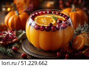 Delicious Autumn Hot Festive Punch made with orange juice, cranberries and cinnamon sticks. Spicy warm beverage served in a pumpkin shaped glass bowl. Ideal for fall gatherings. Seasonal mulled drink. Стоковое AI-изображение, AI-художник Марина Демидюк / Фотобанк Лори