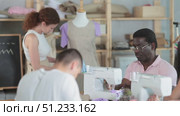 Adults focusing on sewing and pattern work during beginner workshop. Стоковое видео, видеограф Яков Филимонов / Фотобанк Лори
