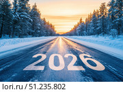 The text 2026 on the road with beautiful natural Lapland landscape and sunset sky. Стоковое AI-изображение, AI-художник Irina Kuchugurina/Gaudy / Фотобанк Лори