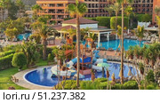 Indulge in a Luxury Resort featuring Multiple Pools and Exciting Water Slides in a Tropical Paradise. Стоковое видео, видеограф Vladimir Vintonjak / Фотобанк Лори