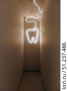 A Creative Dental Corridor Enhanced With a Striking Neon Tooth Light for Visual Impact. Стоковое фото, фотограф Cantemir Dumitru / Фотобанк Лори