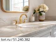 Modern golden faucet and marble stone sink. Stylish white sink, faucets in a light interior. Copper brass tap. Domestic Appliances. Clean bright bathroom. Household equipment. New Contemporary style. Стоковое AI-изображение, AI-художник Марина Демидюк / Фотобанк Лори