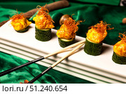 Gastronomic Delicacies of a Far East Restaurant on Jade Colored Silks. Стоковое фото, фотограф Aleksandr Golubev / Фотобанк Лори