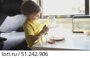 Young child mixing ingredients in bowl at home. Стоковое видео, видеограф Константин Шишкин / Фотобанк Лори