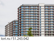 Modern High Rise Apartment Buildings with Repeating Balconies and Glass Facade. Стоковое фото, фотограф Zydrius Tartenis / Фотобанк Лори