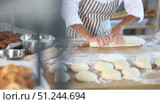 Closeup on pastry chef woman's hands kneading dough on table at bakery, culinary arts. Стоковое видео, видеограф Яков Филимонов / Фотобанк Лори