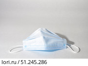 Medical mask on white background, disposable face mask for virus protection. Copy space. Стоковое фото, фотограф Зарифа Арсланова / Фотобанк Лори