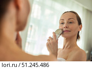 Middle-aged Woman Practices Skin Care Routine With Electrical Device in Her Home. Стоковое фото, фотограф Aleksandr Golubev / Фотобанк Лори