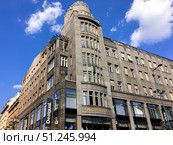 Prague, Czech Republic, July 24, 2018: Koruna Palace on Wenceslas square. Commercial building with tower, bottom view. Sightseeing of European historic capital city. Редакционное фото, фотограф Olga Monako / Фотобанк Лори