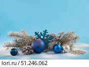 Christmas card with fir branches and Christmas decorations on a light blue background. Стоковое фото, фотограф Ирина Толокновская / Фотобанк Лори