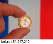 French 10 Franc Coin Held by Fingers with France Flag. Стоковое фото, фотограф Sergakoff / Фотобанк Лори