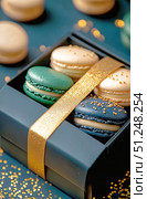 Elegant Macaron Gift Box With Green, Gold, and Blue Treats for Special Occasions. Стоковое AI-изображение, AI-художник Юлия Гапеенко / Фотобанк Лори