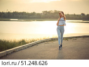 Young beautiful caucasian blonde girl listening to music with smartphone walking and dance in the city with headphones smiling - relax, youth, emancipation concept. Стоковое фото, фотограф Арзюков Вадим Николаевич / Фотобанк Лори