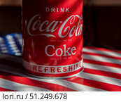 Coca-Cola Classic Drink Can on American Flag Background. Стоковое фото, фотограф Sergakoff / Фотобанк Лори