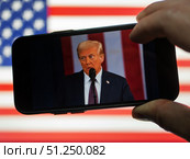 New US President Trump's Inaugural Speech Viewed on Smartphone. Редакционное фото, фотограф Sergakoff / Фотобанк Лори
