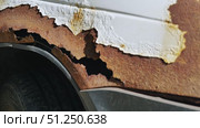 Rust destroying white car bodywork creating holes in metal fender. Стоковое видео, видеограф Mikhail Davidovich / Фотобанк Лори