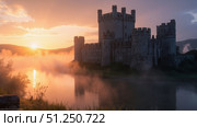 Dramatic sunrise illuminating medieval castle shrouded in fog. Стоковое фото, фотограф David Kashakhi / Фотобанк Лори