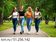 Happy women in blue jeans walking in summer park. Стоковое фото, фотограф Андрей Аркуша / Фотобанк Лори
