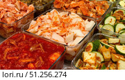 Glass containers overflowing with colorful fermented kimchi delights. Стоковое фото, фотограф David Kashakhi / Фотобанк Лори