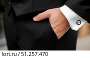 Close-up of formal attire showcasing a black dress shirt and slacks. Стоковое AI-изображение, AI-художник Katsiaryna Repich / Фотобанк Лори