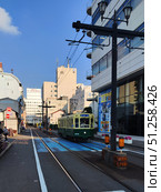 Nagasaki, Japan - May 12, 2025. Tram in Dejima District. Стоковое фото, фотограф Константин Никитеев / Фотобанк Лори