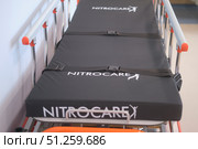 Close up view of empty hospital gurney Nitrocare with black mattress and safety straps. Medical transport concept for patient care and emergencies - Moscow, Russia, September 06, 2025. Редакционное фото, фотограф Андрей Журавлев / Фотобанк Лори