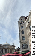 Galata Tower in Istanbul, view from the narrow street Narrow street with Galata Tower and historic building in Beyoglu district, Istanbul, Turkey Beautiful view of city street with different stores. Редакционное фото, фотограф Zita Khasanova / Фотобанк Лори