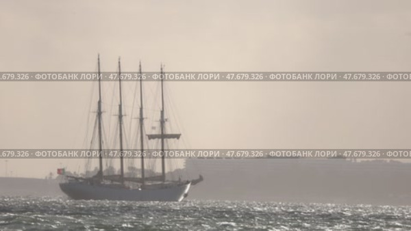 15 April 2025 - Lisbon, Portugal - Four masted sailing ship navigating coastal waters. Редакционное видео, видеограф Константин Шишкин / Фотобанк Лори