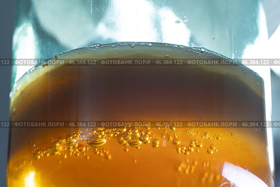 A Beautifully Sparkling Amber Beverage Delicately Poured into a Glass for Your Enjoyment. Стоковое фото, фотограф Ольга Коваленко / Фотобанк Лори