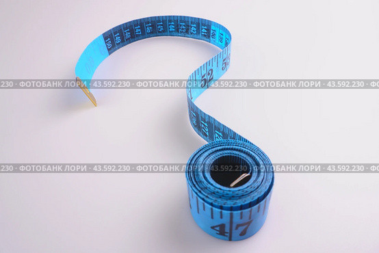 A blue measuring tape on a white background in the form of a question mark. Стоковое фото, фотограф Ярославский Максим / Фотобанк Лори