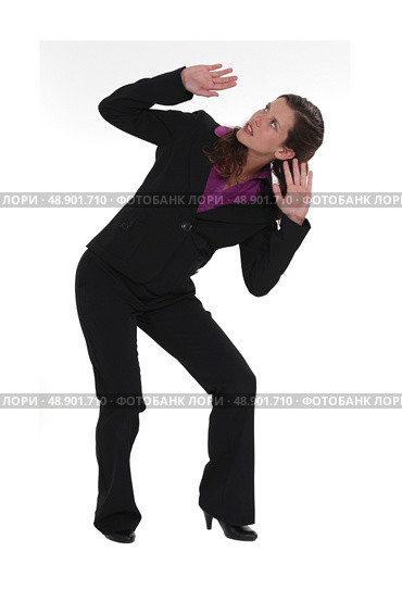 A businesswoman afraid of something falling from the ceiling. Стоковое фото, агентство Ingram Publishing / Фотобанк Лори
