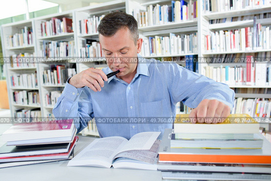 a busy man in the library. Стоковое фото, агентство Ingram Publishing / Фотобанк Лори