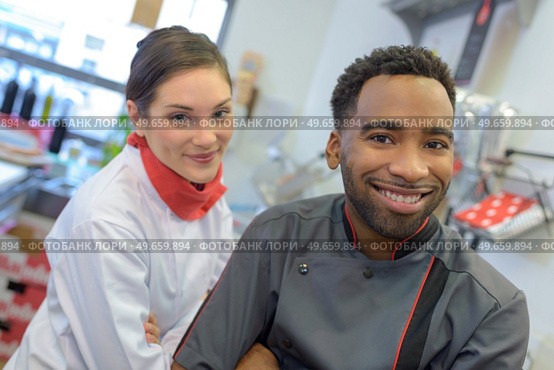 a butcher couple ordering stock. Стоковое фото, агентство Ingram Publishing / Фотобанк Лори