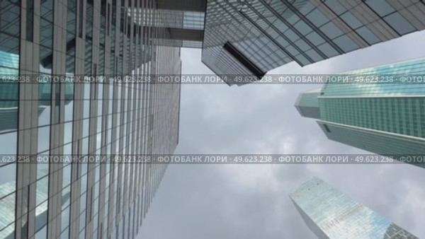 A city skyline with tall buildings and a cloudy sky. Стоковое видео, видеограф Ярославский Максим / Фотобанк Лори