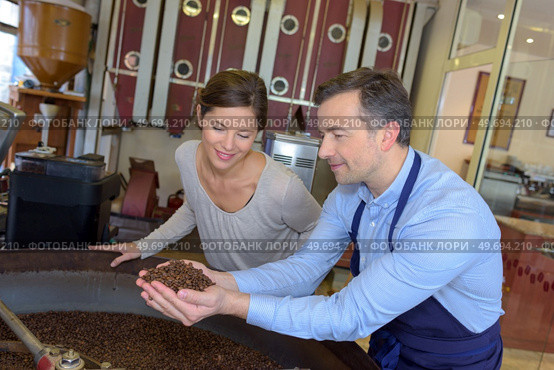 a couple scooping the coffee beans. Стоковое фото, агентство Ingram Publishing / Фотобанк Лори